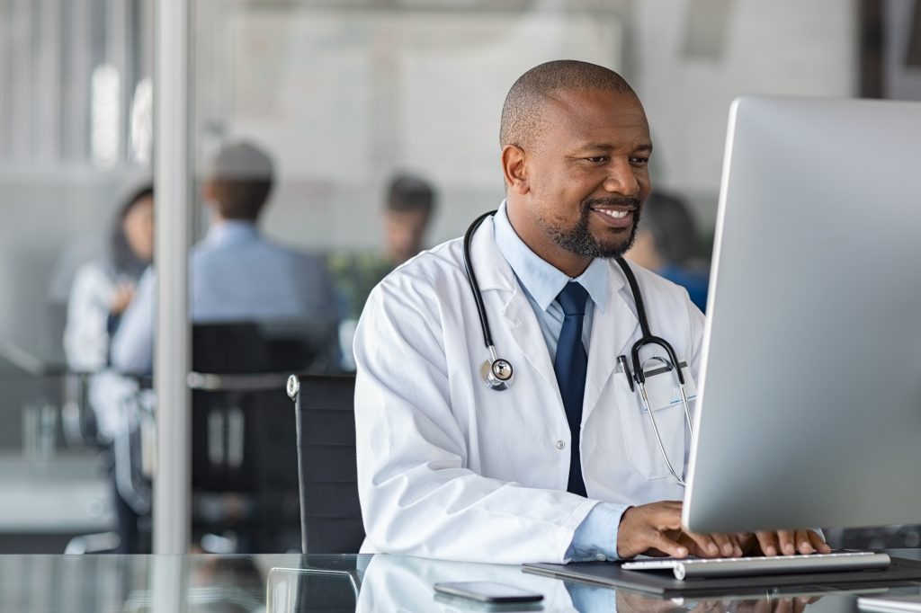 a Doctor using a computer to access EHRs